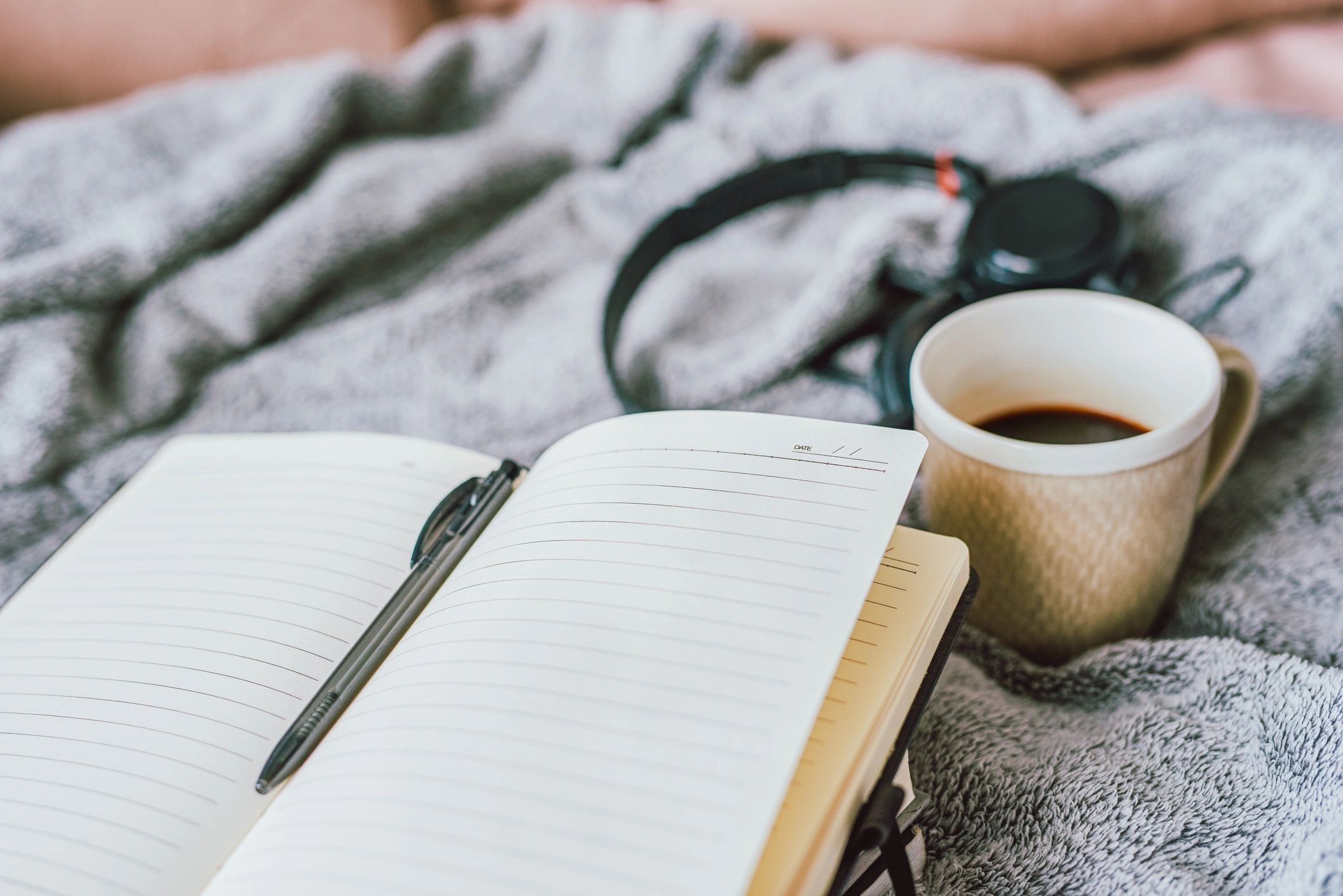 Open notebook with writing notes and pen