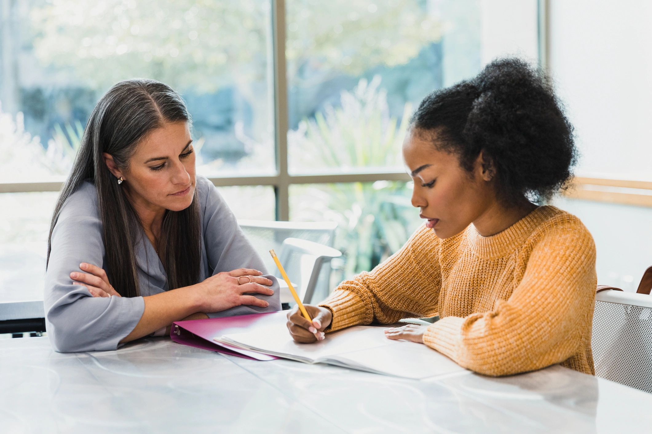 Teacher supporting a student during practice