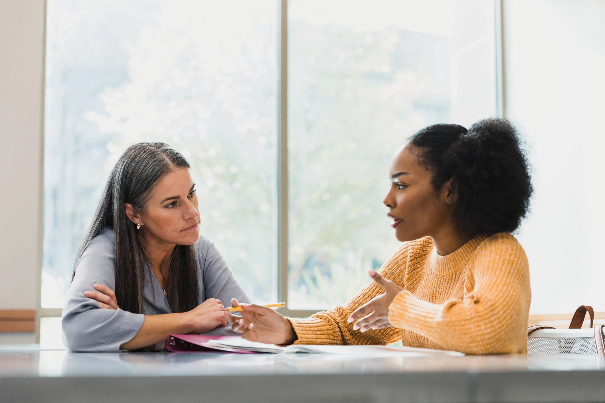 Teacher helping a student with writing